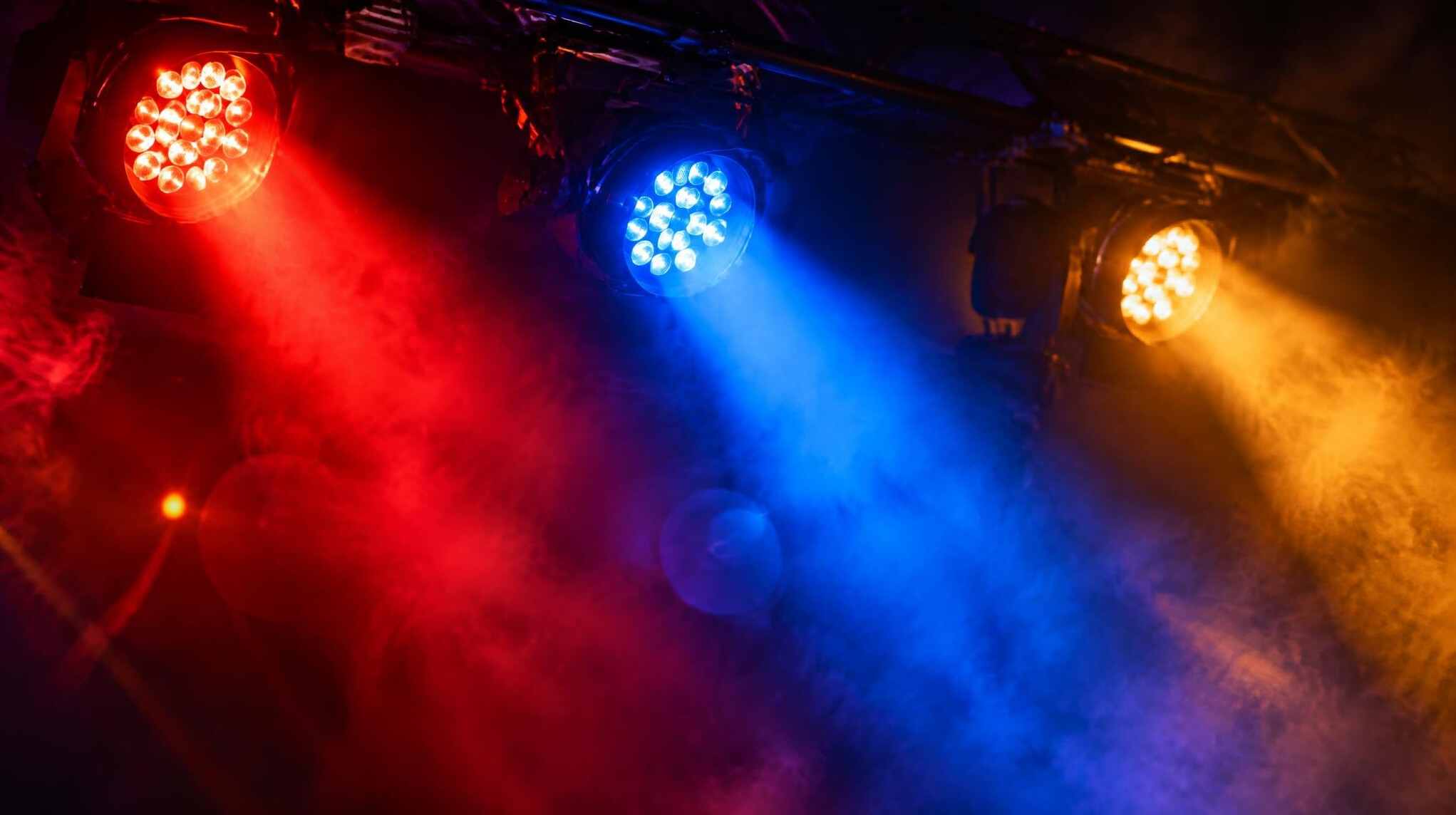 Close-up of colorful concert stage lights with lens flare